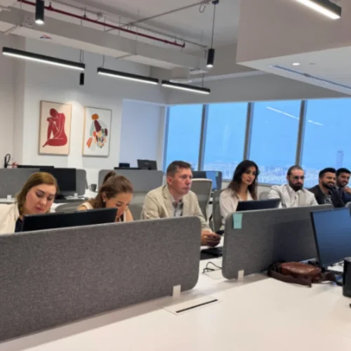 Russian team of Mencis International Ltd working in a modern corporate office environment