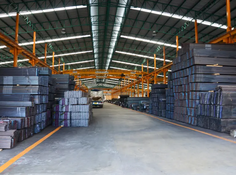 Steel storage warehouse operated by MENCIS International, showcasing industrial raw material handling and logistics.